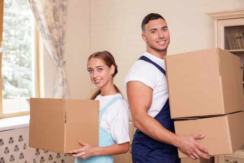 Removalists carrying furniture safely through a Chelsea home