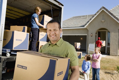 Professional movers carrying furniture during a same day move in Chelsea