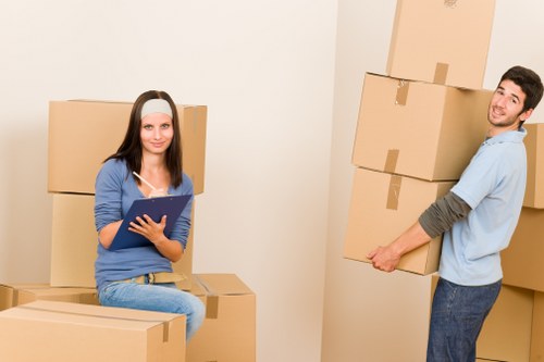 Removal specialists handling furniture in a Chelsea property